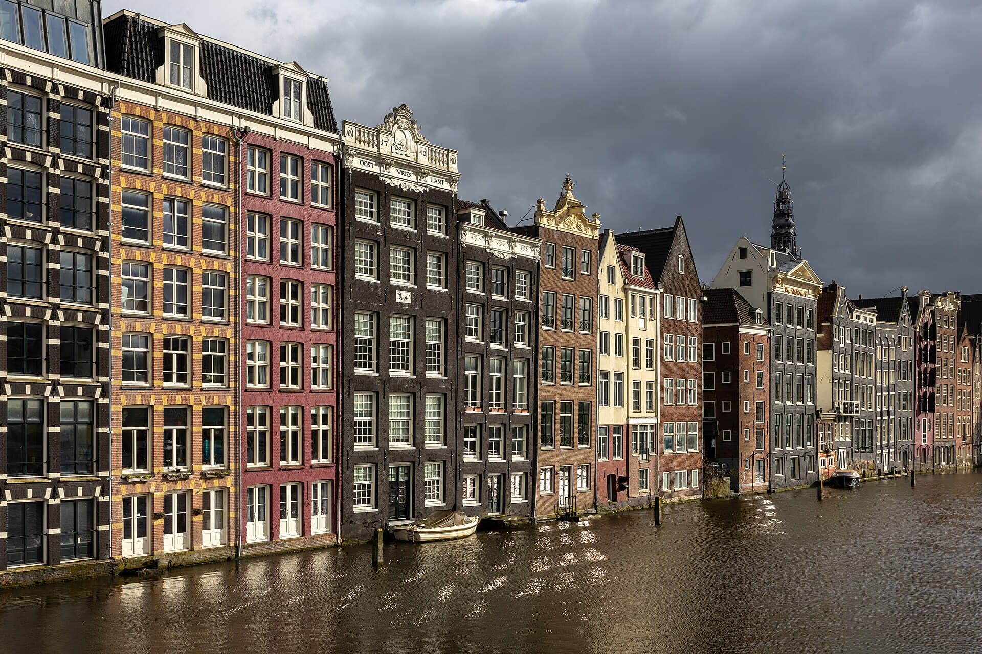 Contextual image of Colorful canal houses at golden hour in Damrak avenue Amsterdam the Netherlands
